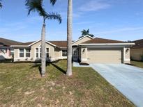 Charming single-story home featuring a well-maintained lawn and a two-car garage at 8603 Primrose Dr, Kissimmee, FL 34747