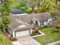 Charming single-Gathering home with a two-car garage, screened pool, and well-manicured lawn at 14540 Pointe East Trl, Clermont, FL 34711