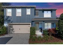 Charming two-story home featuring a 2-car garage, beautifully landscaped front yard, and inviting front porch at 219 Meghan Cir, Deland, FL 32724