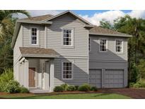 Charming two-story home with gray siding, a covered entry, and a two-car garage at 30158 Rustic Mill St, Mount Dora, FL 32757