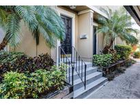 Inviting front entrance featuring a decorative door, well-kept landscaping, and a charming set of stairs at 311 W Lake Faith Dr, Maitland, FL 32751