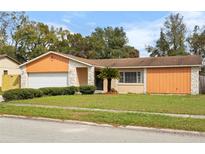 Charming single-story home with a well-maintained lawn and landscaping at 453 Weathersfield Ave, Altamonte Springs, FL 32714