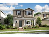 Charming two-story home featuring stone accents, covered porch, and a professionally landscaped front yard at 15126 Field Daisy Dr # 205, Winter Garden, FL 34787