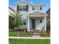 Charming two-story home with a blue front door, tidy landscaping, and freshly cut green grass at 15543 Gentle Rain Dr # 197, Winter Garden, FL 34787