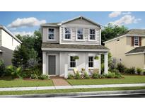 Charming two-story home featuring a quaint front porch with seating and lush landscaping at 15567 Gentle Rain Dr # 194, Winter Garden, FL 34787