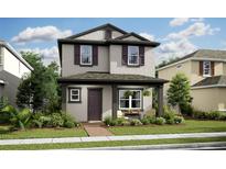 Charming two-story home featuring neutral stucco, a covered porch, and well-manicured landscaping at 15585 Gentle Rain Dr # 191, Winter Garden, FL 34787