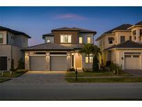 Beautiful two-story home featuring a well-manicured lawn, stone accents, and a spacious two-car garage at 15847 Vetta Dr, Bella Collina, FL 34756