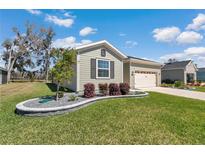 Charming single-Gathering home boasts a landscaped front yard and attached two-car garage at 7699 Sw 74Th Loop, Ocala, FL 34481