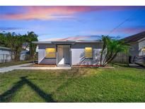 This exterior shows a house and its front lawn at dusk at 859 Neuse Ave, Orlando, FL 32804