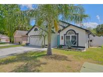 Charming single-Gathering home showcasing a lush green yard and a beautiful palm tree at 868 Shell Ln, Longwood, FL 32750
