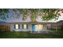 Charming single-story home featuring a cozy front porch and vibrant blue door and shutters at 1315 Overdale St, Orlando, FL 32825