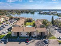 Aerial view of condo complex with lakefront views, pool, parking, and beautifully landscaped grounds at 562 Orange Dr # 33, Altamonte Springs, FL 32701
