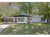 Charming single-story home featuring a covered carport, attractive brickwork and a classic front door at 6331 Lake Lerla Dr, Apopka, FL 32712
