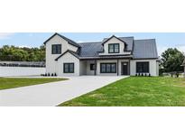 Striking two-story modern farmhouse with black trim and a well manicured lawn at 1070 Lake Ariana Blvd, Auburndale, FL 33823