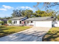 Charming single-story home with a well-maintained lawn, brick-lined porch, and a two-car garage at 1231 Glastonberry Rd, Maitland, FL 32751