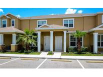 Inviting townhouse featuring a well-maintained lawn and a shared entrance, perfect for comfortable living at 1523 Still Dr, Clermont, FL 34714