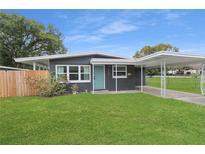 Charming single-story home with a well-manicured lawn and a covered carport at 1708 Bennett Rd, Orlando, FL 32803
