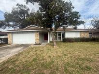 Charming single-story home featuring a well-maintained lawn and mature trees at 204 W Cottesmore Cir, Longwood, FL 32779