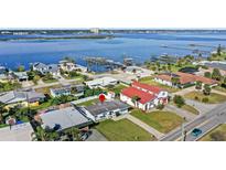 An aerial view of single-story home showcasing its waterfront location and neighborhood at 3226 S Peninsula Dr, Daytona Beach Shores, FL 32118