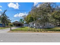 Charming single-story home with well-maintained lawn, a carport, and multiple mailboxes at 519 Pearl St, Mascotte, FL 34753