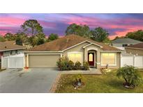 Charming single-story home with a well-manicured lawn and beautiful landscaping at 639 Mesilla Dr, Kissimmee, FL 34758