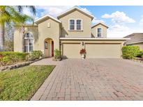 Charming two-story home featuring a well-maintained lawn and a welcoming three-car garage at 1420 Prairie Oaks Dr, St Cloud, FL 34771