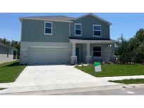Charming two-story home featuring a two-car garage and a well-manicured front yard at 2005 Canton Park Dr, Winter Haven, FL 33881