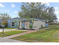 Charming single-story home with manicured lawn, brick walkway, and a serene neighborhood setting at 2539 Antilles Dr, Winter Park, FL 32792