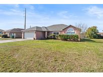 Charming single-story home featuring a two-car garage and well-maintained landscaping at 2540 Courtland Blvd, Deltona, FL 32738