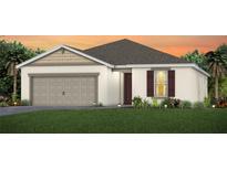 Charming single-story home featuring a two-car garage, manicured lawn, and classic architectural details at 2721 Serenity Meadow Dr, Kissimmee, FL 34744
