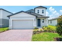 Charming two-story home featuring a brick driveway, well-maintained landscaping, and attached two-car garage at 470 Amadoras Way, St Cloud, FL 34771