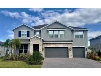 Charming two-story home with a three-car garage and stone accents at 760 Annabell Ridge Rd, Minneola, FL 34715