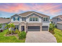 Beautiful two-story home with a three-car garage, stone accents, and well-manicured landscaping at 760 Annabell Ridge Rd, Minneola, FL 34715