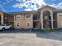 Well-maintained condo building with private parking and easy access to units via outdoor staircases at 8830 Coral Palms Ct # A, Kissimmee, FL 34747