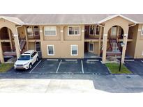 Well-maintained condo building with private parking and easy access to upper-level units via outdoor staircases at 8830 Coral Palms Ct # A, Kissimmee, FL 34747