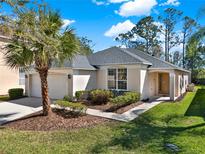 Charming single-story home with a well-manicured lawn, mature landscaping, and an attached two-car garage at 151 Castaway Beach Way, Kissimmee, FL 34746