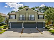 Charming townhome with a two-story facade, balconies, and three garages at 1552 Broken Oak Dr # B, Winter Garden, FL 34787