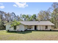 Charming single-story home featuring a well-maintained lawn and mature landscaping at 20240 Sw 95Th St, Dunnellon, FL 34431