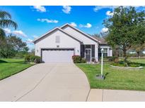 Charming single-story home with a well-manicured lawn and a two-car garage at 25322 Felicity Ct, Leesburg, FL 34748