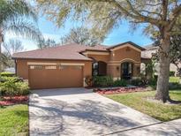 Charming single-story home with a well-manicured lawn, mature trees, and a two-car garage at 3620 Chandler Estates Dr, Apopka, FL 32712