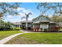 Charming home featuring lush landscaping, a brick walkway, and a well-maintained lawn at 701 Palenci Ct, Winter Springs, FL 32708