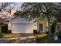 Charming single-story home featuring a well-manicured lawn, brick facade, and a welcoming blue front door at 1493 Hyde Park Dr, Winter Park, FL 32792