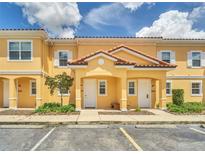 Charming townhome with a private entrance, tile roof, and well-maintained landscaping at 2647 Corvette Ln, Kissimmee, FL 34746