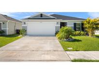 Charming single-story home with a well-manicured lawn and a two-car garage at 3201 Sweet Acres Pl, St Cloud, FL 34772