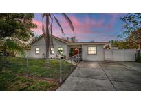 Charming single-story home with a fenced yard and a concrete driveway, perfect for Gathering living at 6023 Sage Dr, Orlando, FL 32807