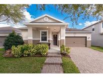 Charming single-story home featuring a well-manicured lawn, brick walkway, and an attached two-car garage at 8813 Tatara, Orlando, FL 32836