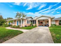 Charming single-story home with a well-manicured lawn and covered entrance at 936 N Baker St, Mount Dora, FL 32757