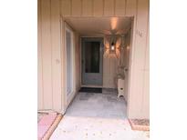 Inviting front door with sidelight, bench, and stylish tile flooring welcomes you home at 116 Crown Oaks Way # 116, Longwood, FL 32779