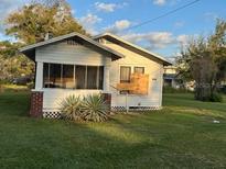 Modest one story home with a screened porch and a lawn at 1803 S Westmoreland Dr, Orlando, FL 32805