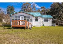 Charming single-story home with a metal roof and cozy front porch at 24813 E Highway 316, Salt Springs, FL 32134